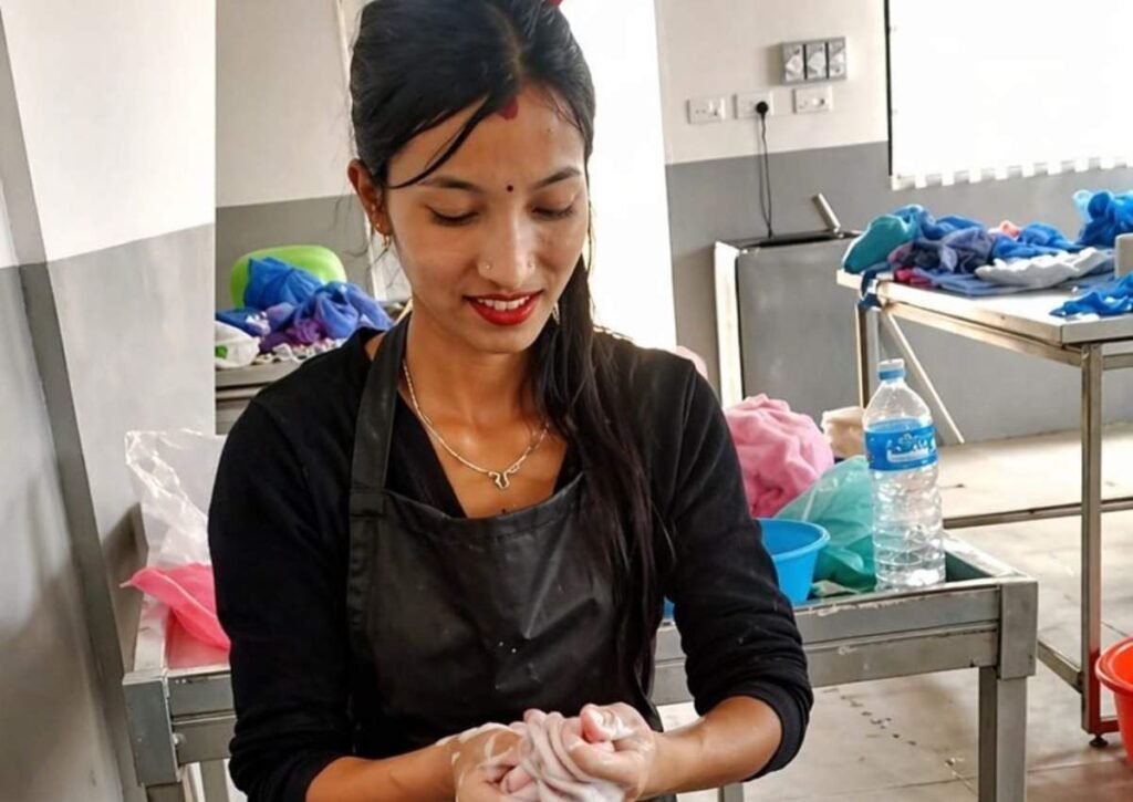 Young Nepali woman artisan Sangita portrait at fair trade felt workshop Hillyarn Nepal