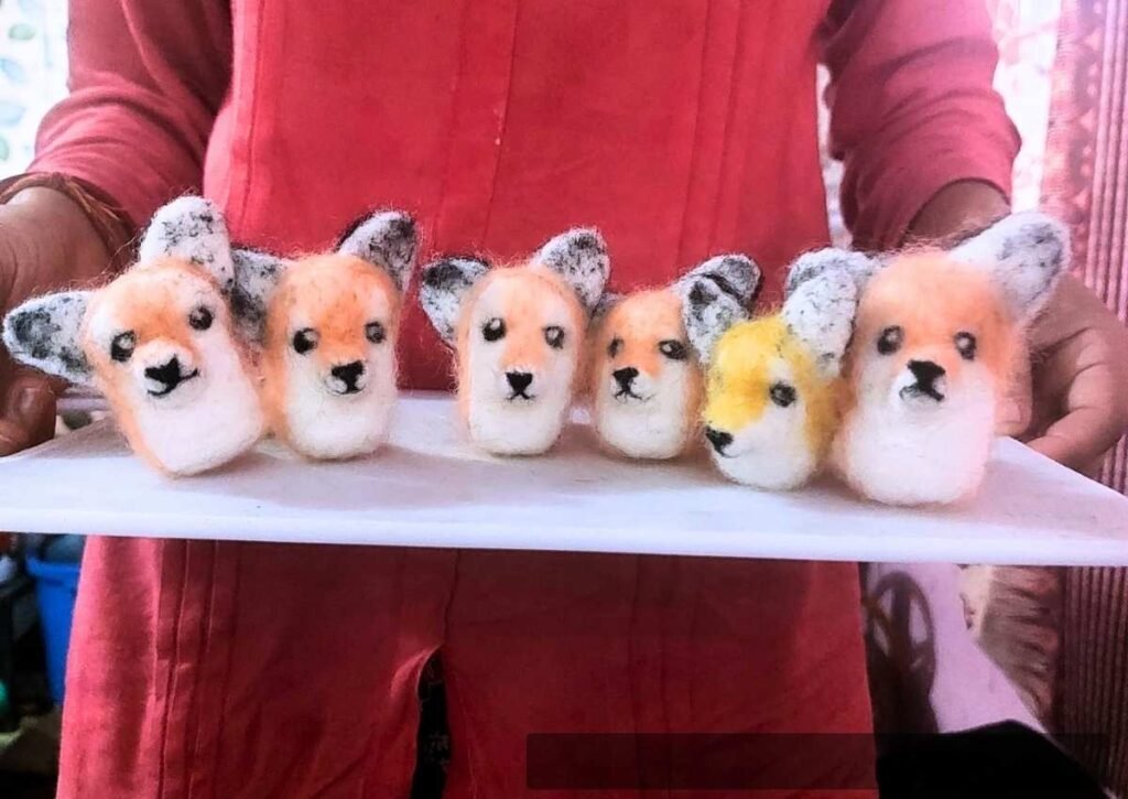 Traditional Nepalese wool felt manufacturer team needle felting small animals by hand