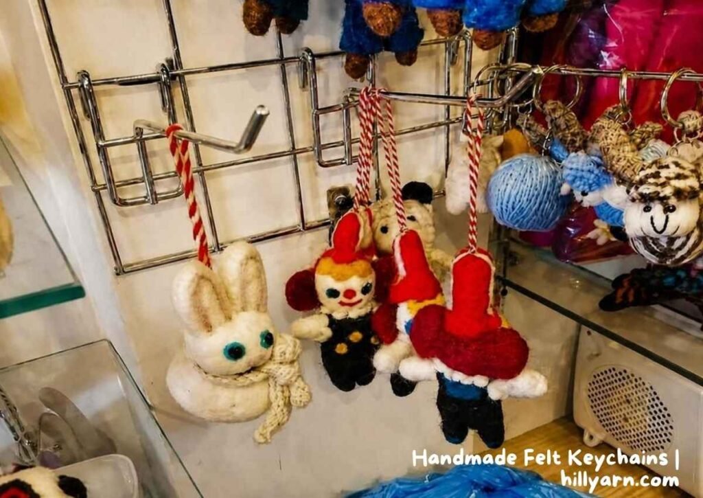 Collection of handmade felt keychains and ornaments displayed in a boutique store