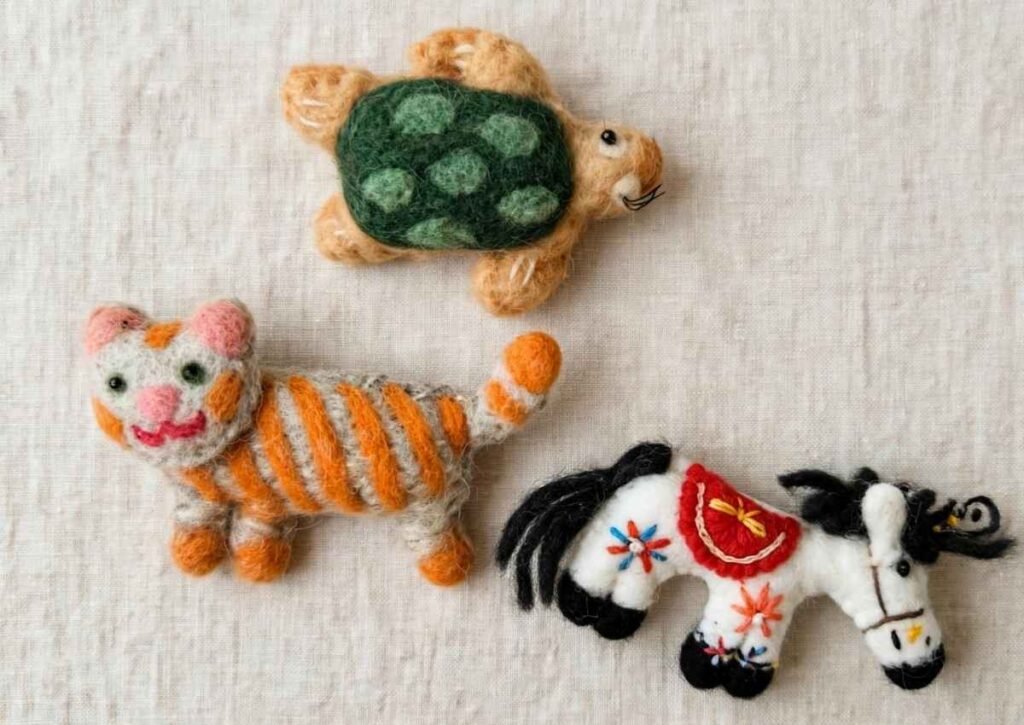 Wholesale handmade needle felted animals from Nepal - cute turtle, striped tiger cat and embroidered white horse toys