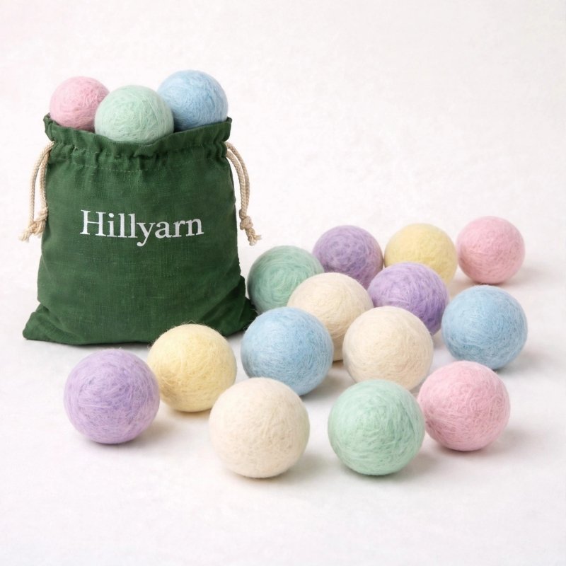 Wholesale pastel wool dryer balls in green Hillyarn cotton bag handmade in Nepal