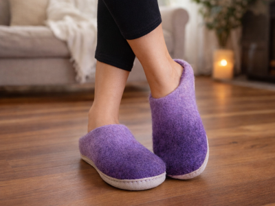 Handmade felt wool slippers with leather soles, sustainable footwear from Nepal, wholesale artisanal shoes.